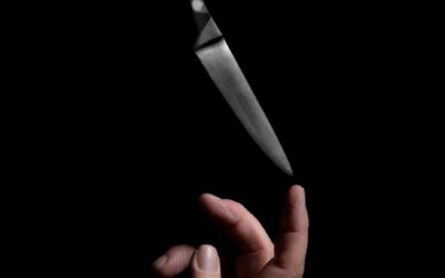 person holding stainless steel bread knife